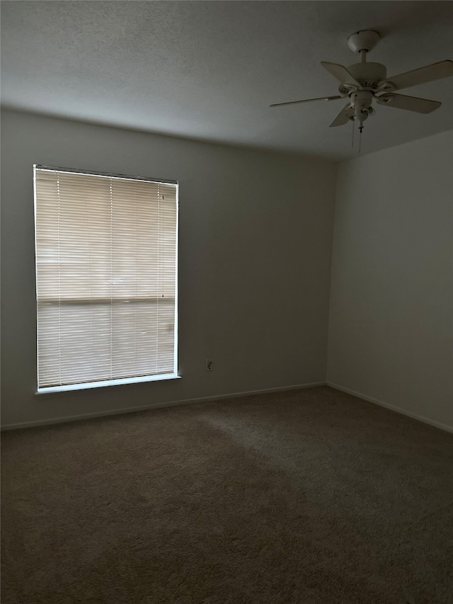 carpeted empty room with a textured ceiling and ceiling fan