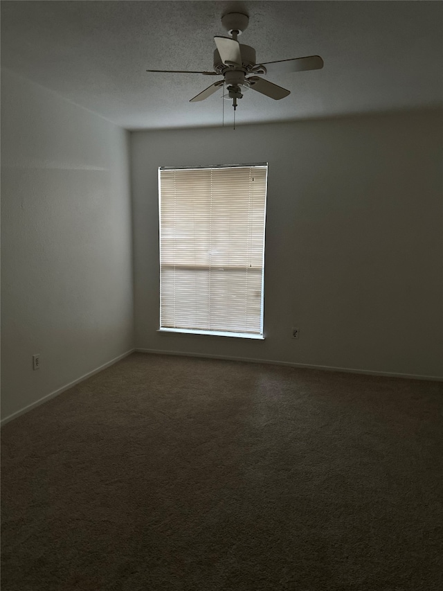 empty room featuring a textured ceiling, ceiling fan, and carpet flooring