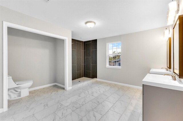 bathroom with vanity, toilet, and a tile shower