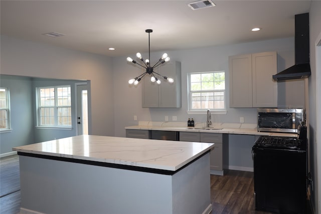 kitchen featuring a center island, an inviting chandelier, dark hardwood / wood-style flooring, sink, and black appliances