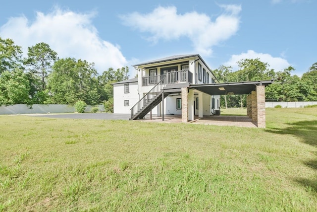 rear view of property with a yard and a carport