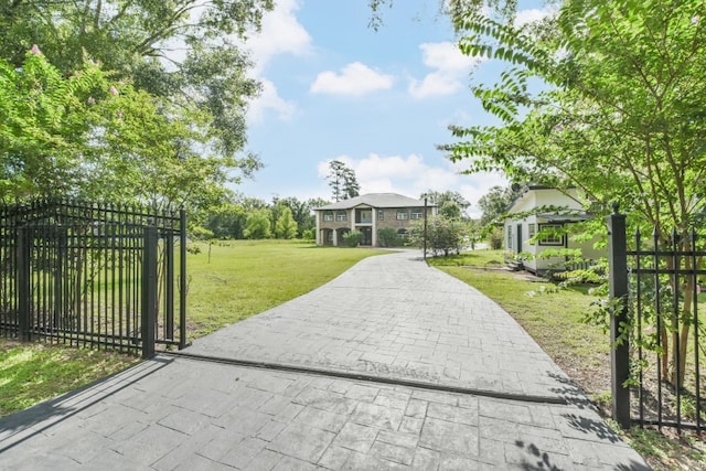 view of gate featuring a lawn