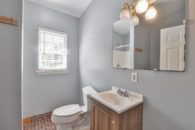 bathroom featuring vanity with extensive cabinet space and toilet