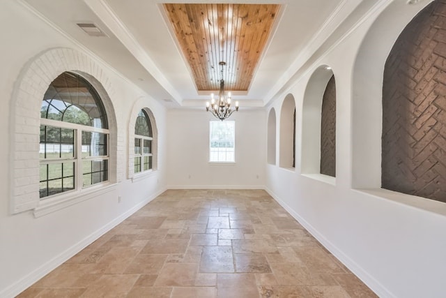 tiled entryway featuring an inviting chandelier, wooden ceiling, and a raised ceiling