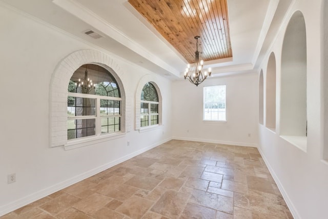 tiled empty room featuring a tray ceiling, wood ceiling, and an inviting chandelier