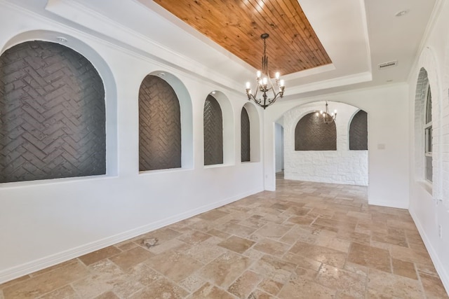 tiled spare room featuring a notable chandelier, a tray ceiling, and wood ceiling