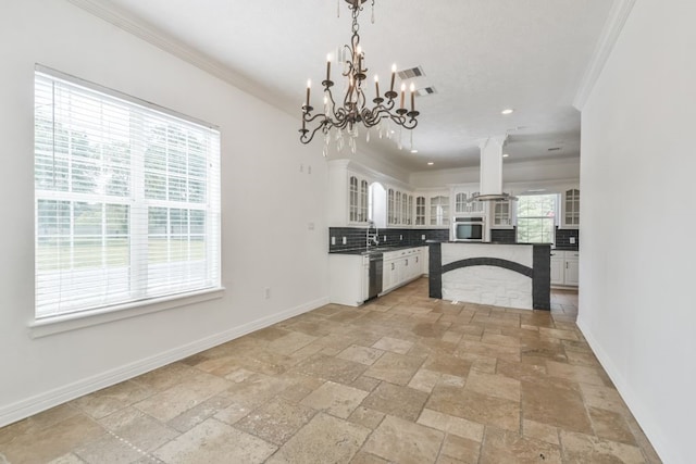 kitchen with plenty of natural light, tasteful backsplash, and light tile flooring