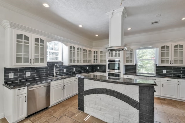 kitchen with stainless steel appliances, white cabinets, sink, tasteful backsplash, and light tile flooring