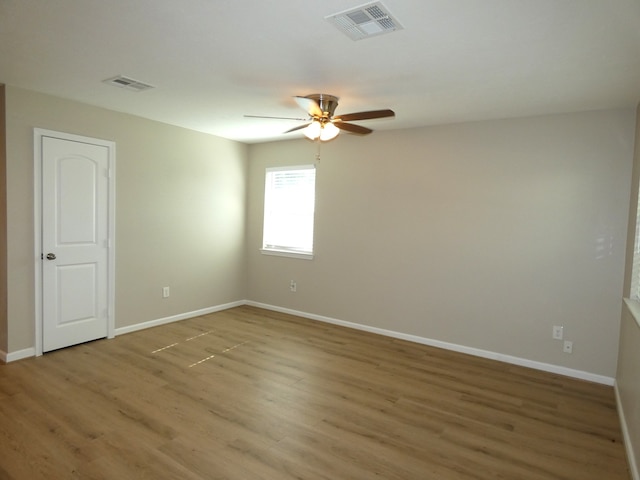 spare room with ceiling fan and hardwood / wood-style flooring