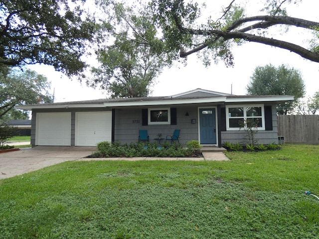 ranch-style home with a front yard and a garage