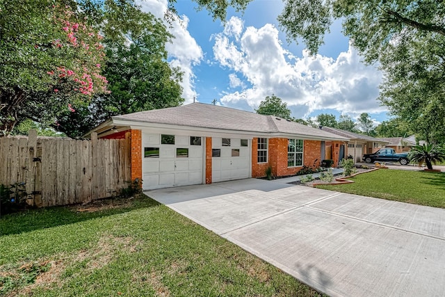 ranch-style home featuring a garage and a front yard