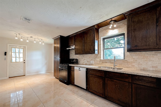 kitchen featuring sink, light stone counters, white dishwasher, black range, and light tile patterned floors