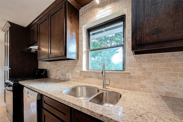 kitchen featuring backsplash, light stone counters, dark brown cabinets, stainless steel appliances, and sink