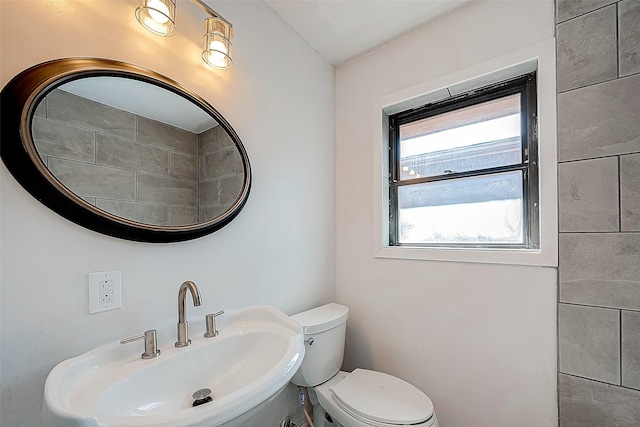 bathroom featuring toilet and sink