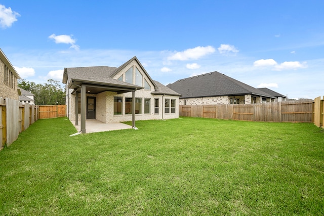 back of house featuring a lawn and a patio area