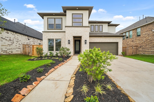 prairie-style home with a front yard and a garage