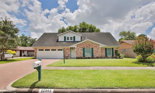 view of front of home with a garage and a front lawn