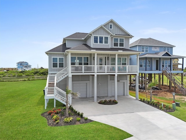 coastal inspired home with covered porch, a garage, and a front lawn