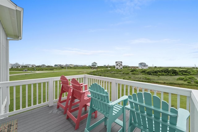 wooden terrace featuring a lawn