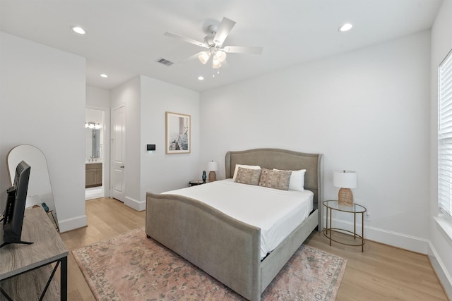 bedroom featuring light wood-type flooring, connected bathroom, and ceiling fan