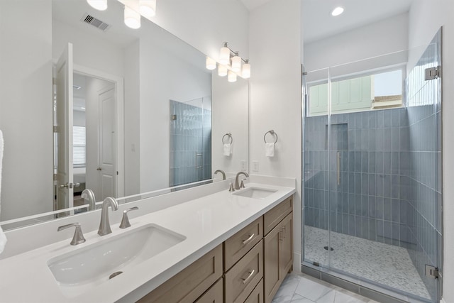 bathroom featuring vanity and a shower with shower door