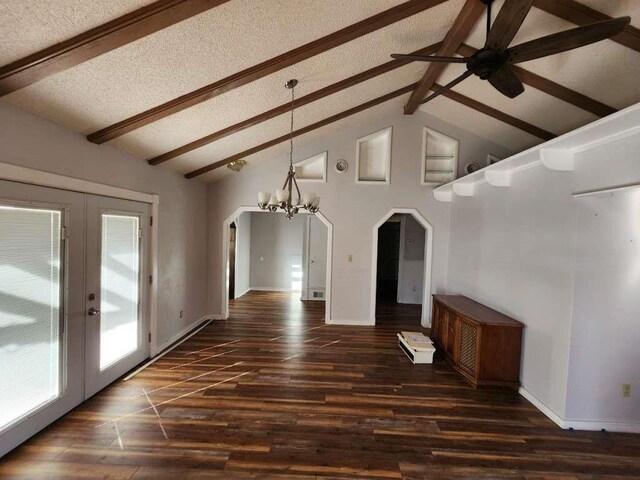 unfurnished dining area featuring dark wood-type flooring, beam ceiling, a textured ceiling, and french doors