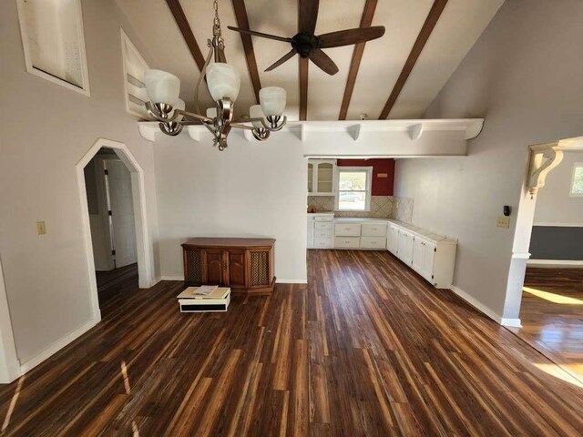 kitchen with high vaulted ceiling, dark hardwood / wood-style floors, white cabinets, beamed ceiling, and backsplash