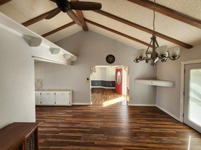 unfurnished dining area with beam ceiling, ceiling fan with notable chandelier, dark hardwood / wood-style floors, and a textured ceiling