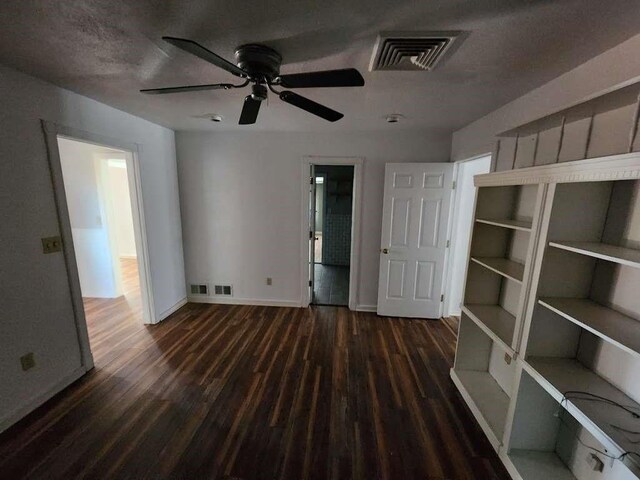 interior space featuring dark hardwood / wood-style floors and a textured ceiling