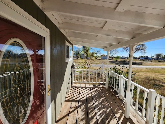 wooden terrace featuring covered porch