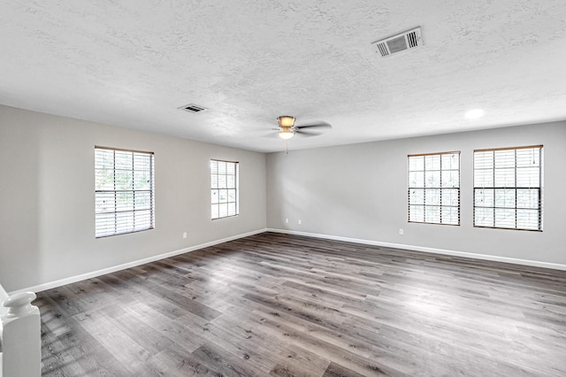 unfurnished room with ceiling fan, a textured ceiling, and wood-type flooring