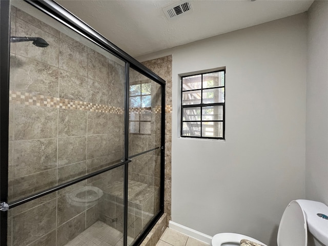 bathroom featuring tile floors, walk in shower, and toilet