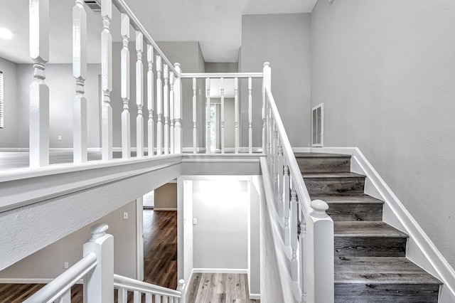 stairs with hardwood / wood-style flooring