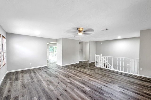 spare room with wood-type flooring, ceiling fan, and a textured ceiling