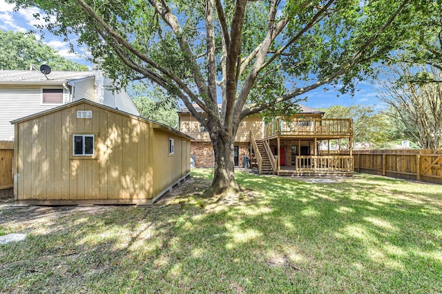 back of house with a wooden deck and a yard