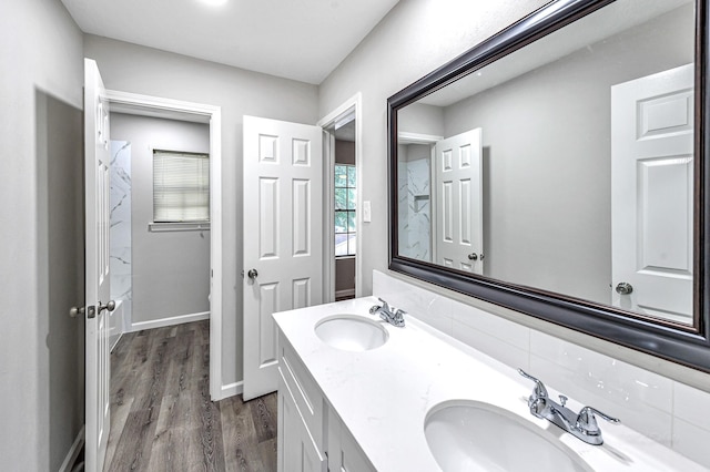 bathroom with hardwood / wood-style floors, dual sinks, and large vanity