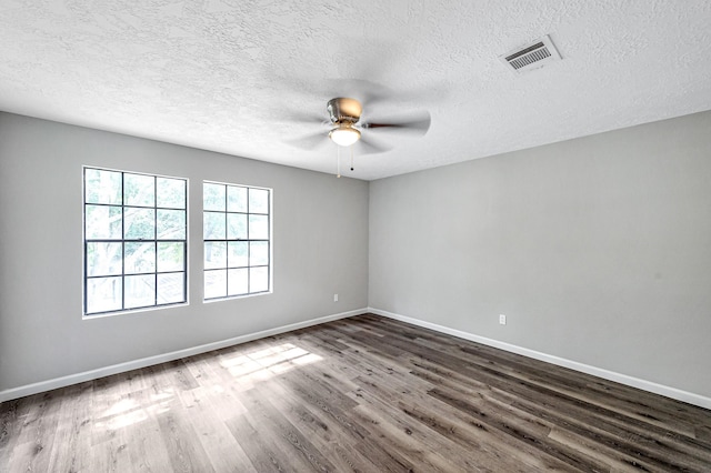 empty room featuring a textured ceiling, wood-type flooring, and ceiling fan