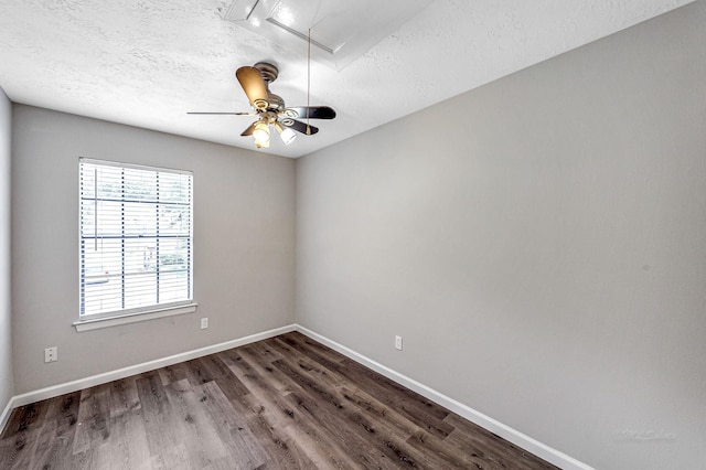 unfurnished room with ceiling fan, dark hardwood / wood-style floors, and a textured ceiling