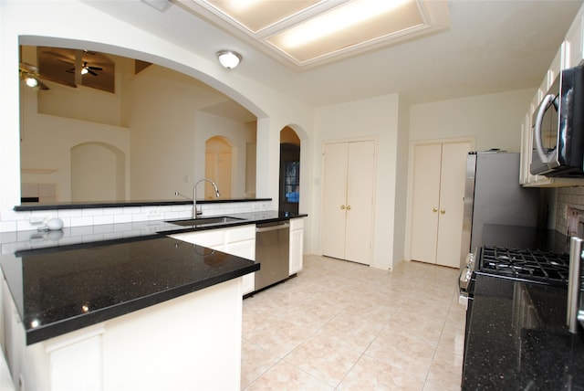 kitchen with sink, decorative backsplash, ceiling fan, light tile patterned flooring, and stainless steel appliances