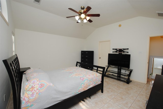 bedroom with ceiling fan, lofted ceiling, and light tile patterned floors