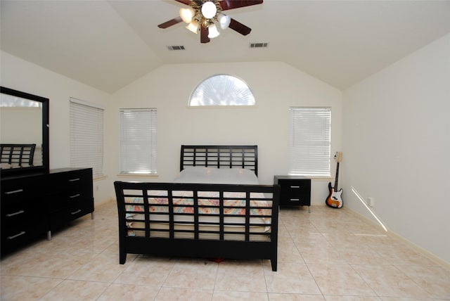 bedroom with ceiling fan, light tile patterned floors, and vaulted ceiling