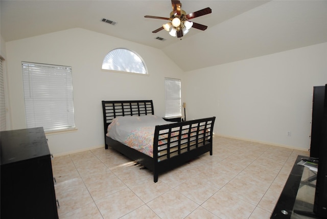 bedroom with ceiling fan, lofted ceiling, and light tile patterned floors