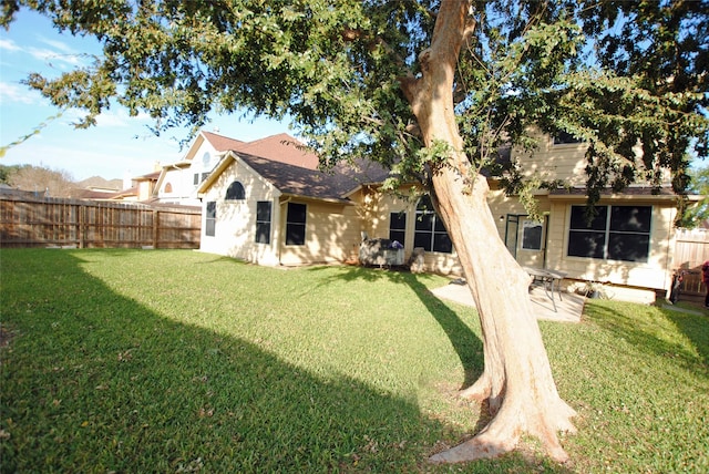 rear view of house with a yard