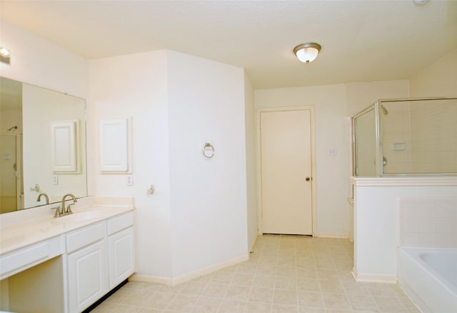 bathroom with vanity and shower with separate bathtub