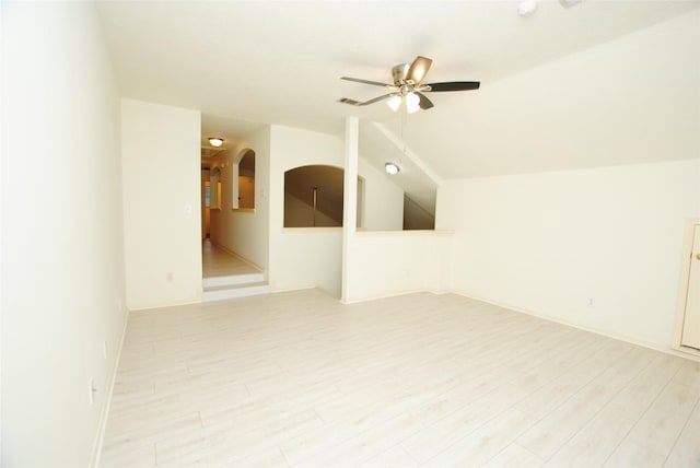 unfurnished room with ceiling fan, light hardwood / wood-style floors, and vaulted ceiling