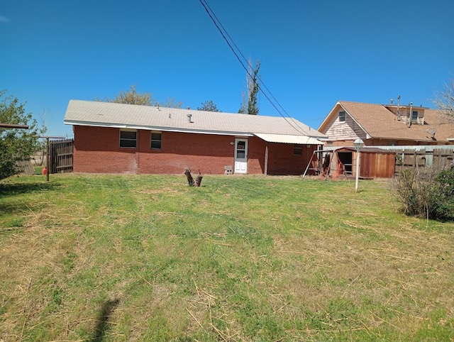 rear view of house with a lawn