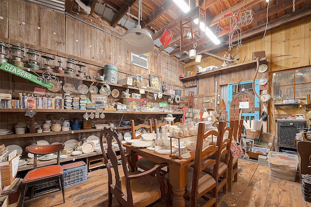 dining room with wooden ceiling, wood walls, wood-type flooring, and vaulted ceiling with beams