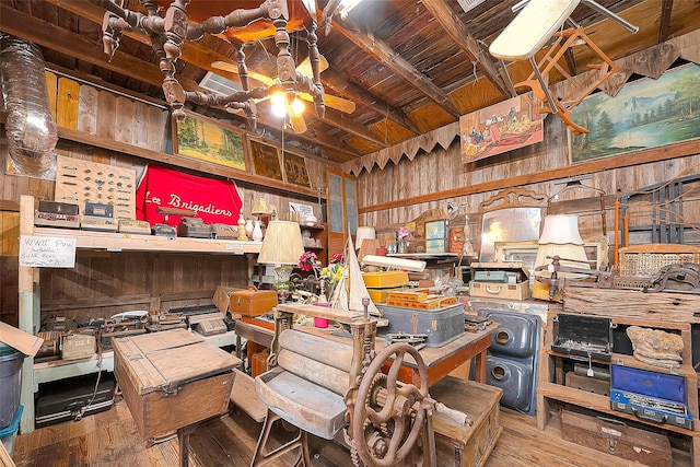 miscellaneous room with hardwood / wood-style flooring, lofted ceiling with beams, wood ceiling, wood walls, and ceiling fan