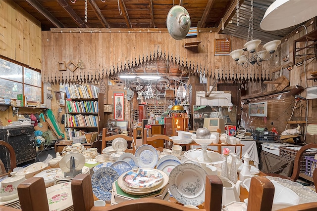 dining area with wood ceiling, high vaulted ceiling, and wood walls