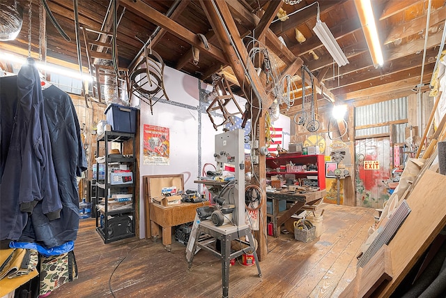 basement with dark wood-type flooring and a workshop area